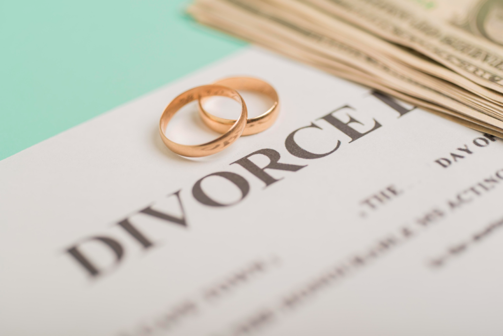 Two wedding rings on a divorce decree paper