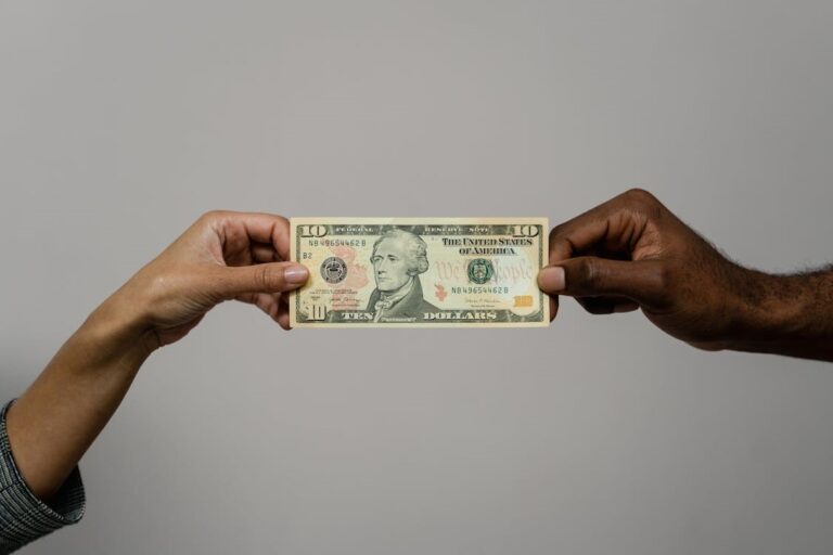 A man giving money to a woman.