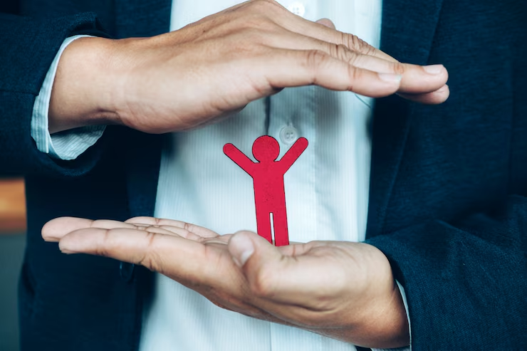 A person holding a human-shaped cardboard cutting