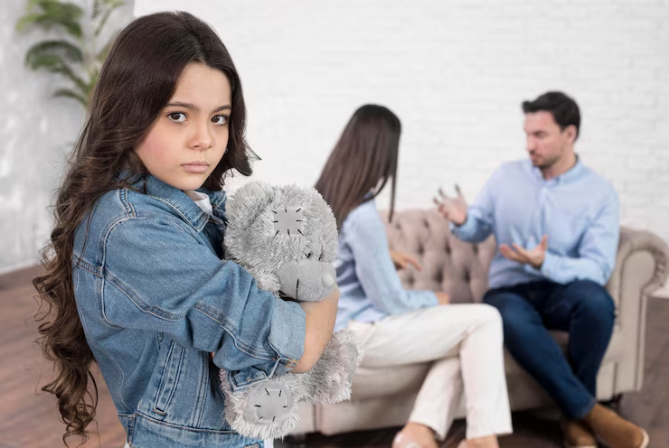 A couple arguing in the presence of a girl
