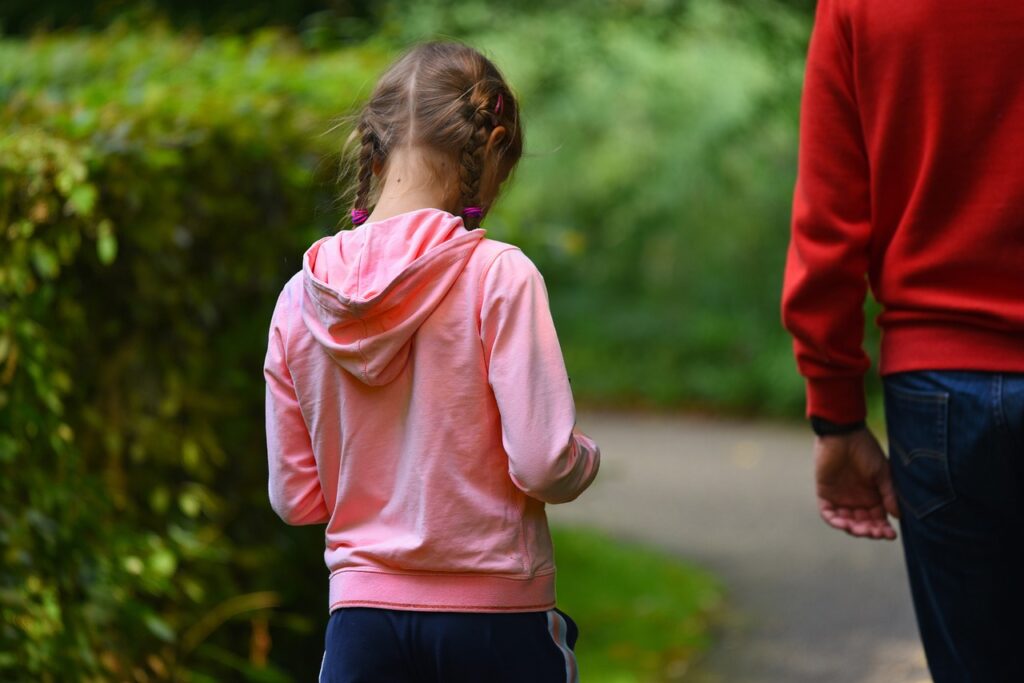A father and her daughter taking a walk