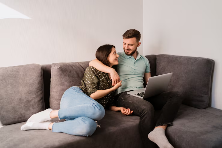 A couple sitting on a sofa