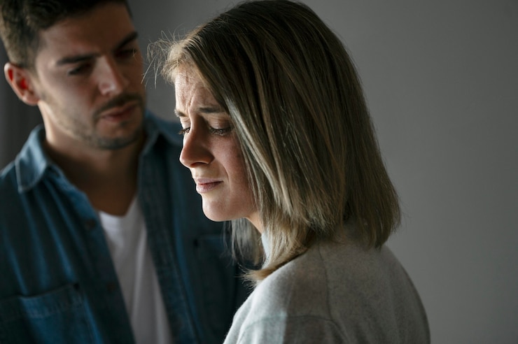 A couple looking disappointed and emotionally distant before filing for a contested divorce