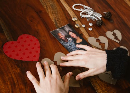 A person holding a torn cardboard cutting
