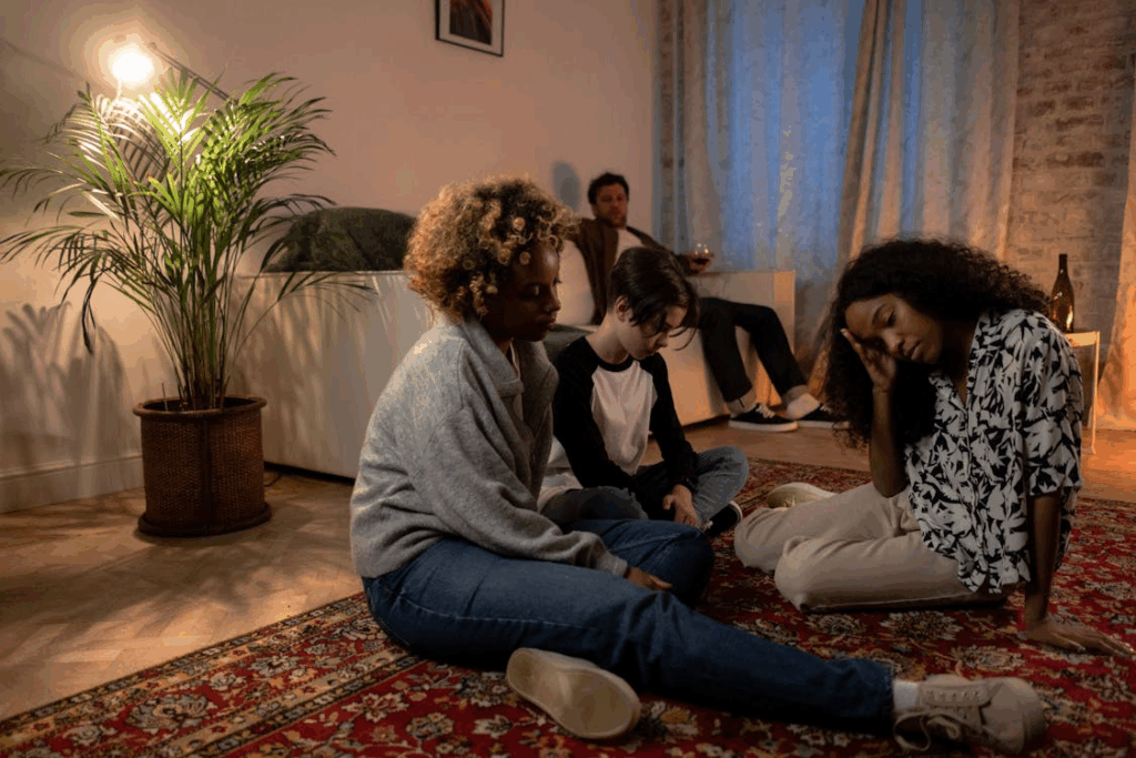 a family sitting on the sofa and floor due to family issues and arguments
