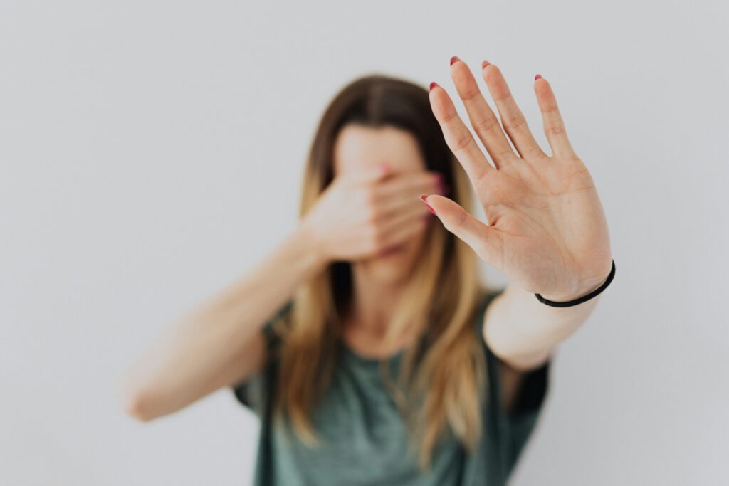 A woman with a hand on her eyes