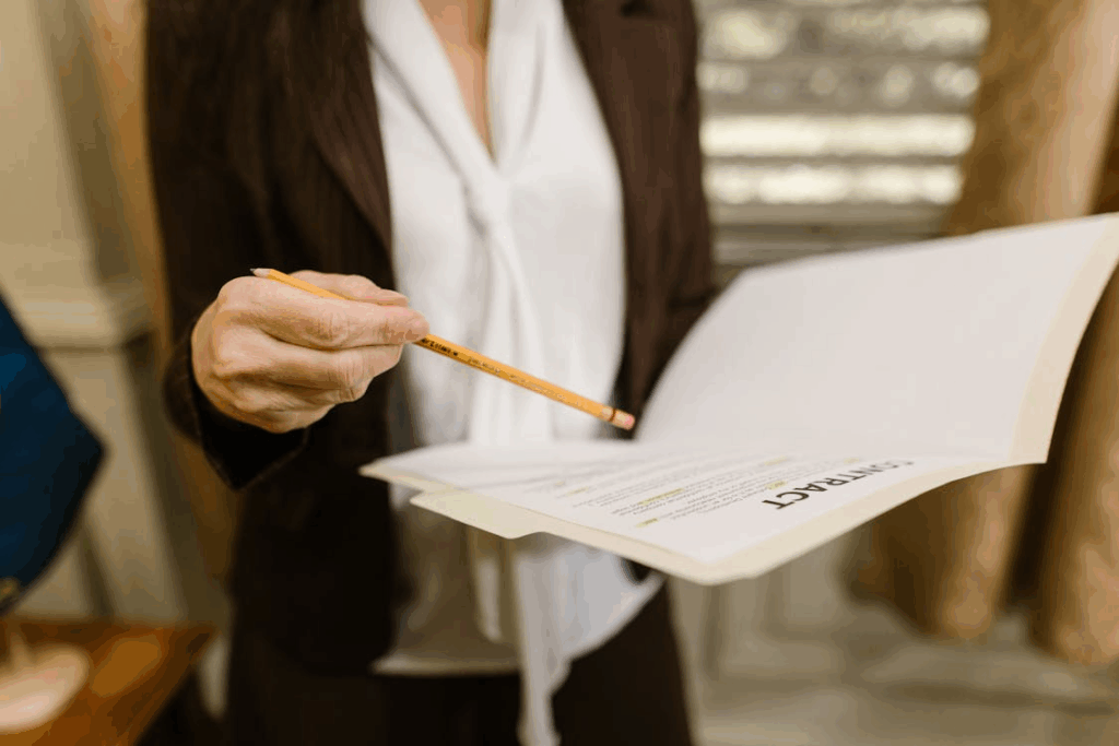 lawyer going through a contract and pointing at it with a pencil