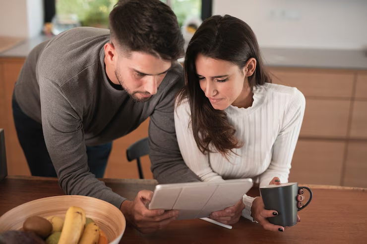 A couple looking at a tablet