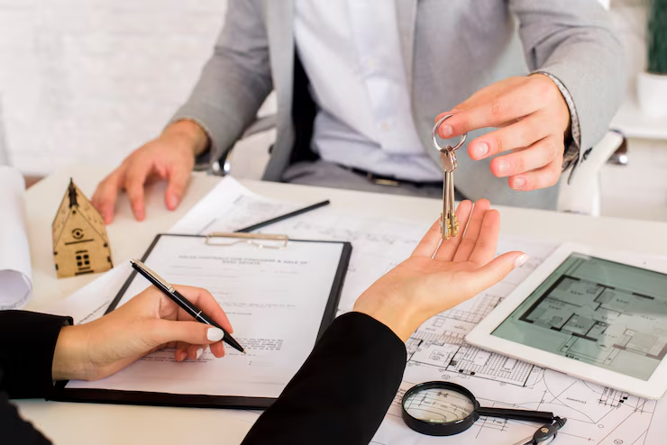 A person handing a set of keys to another person