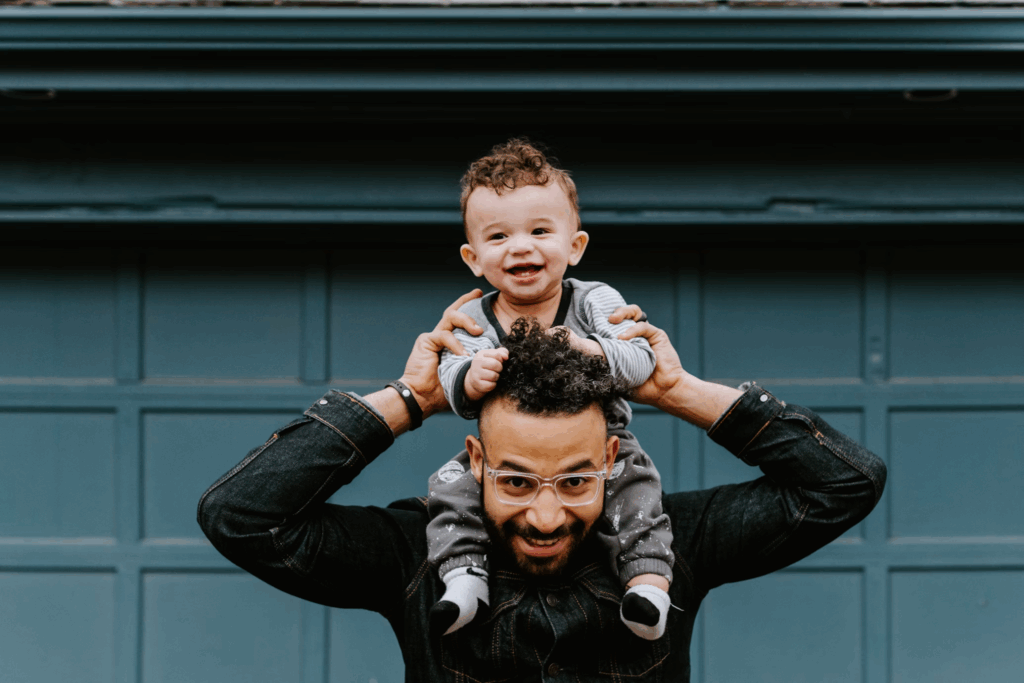 A father carrying his kid on his shoulders