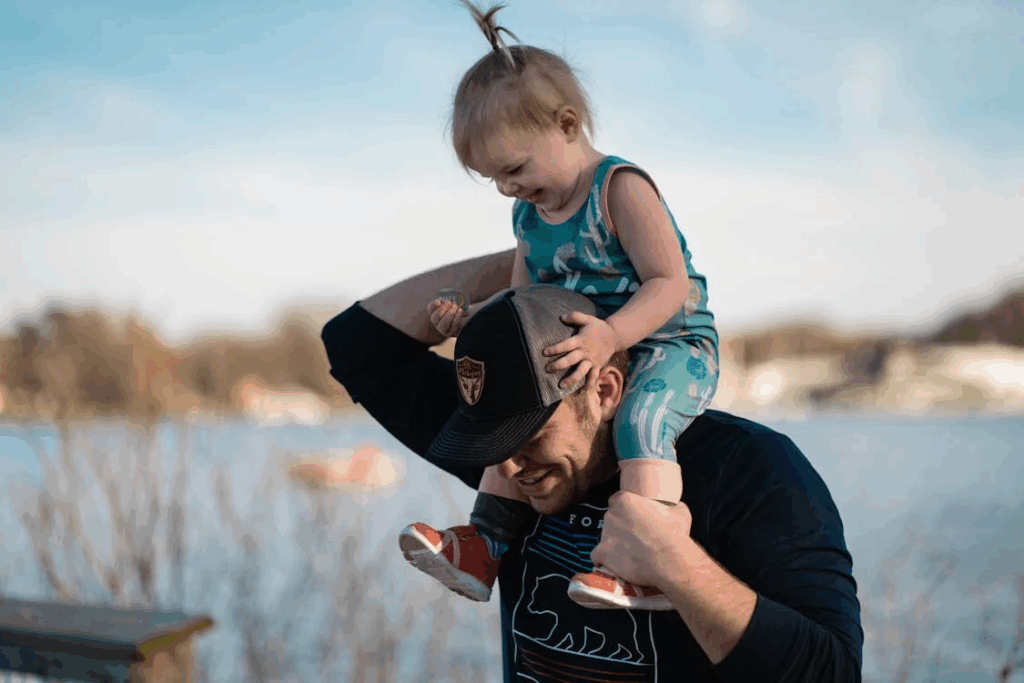 A father carrying a baby on his shoulders