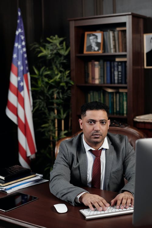 Male lawyer working on a computer at his office desk.