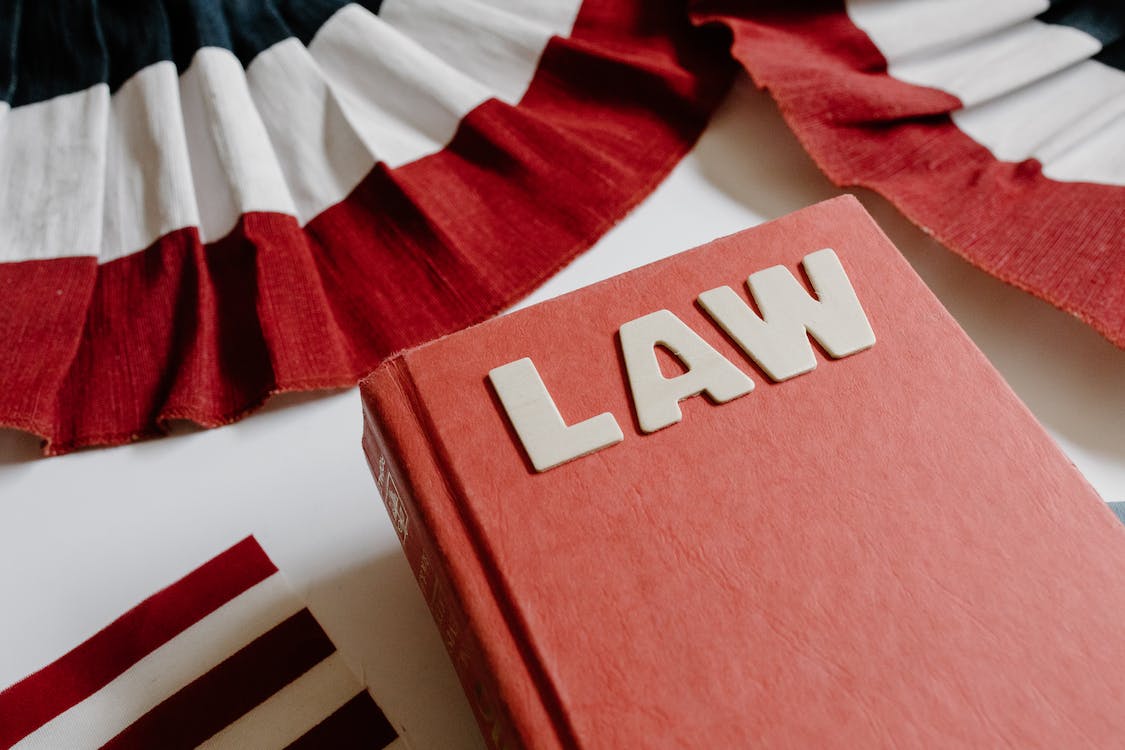 Close-up shot of a law book open on a wooden surface.