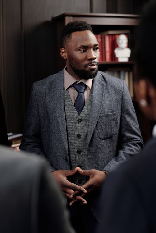 Businessman looking to the side in a professional office setting.