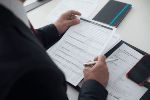 A lawyer holding forms while advising on family law matters in Houston.