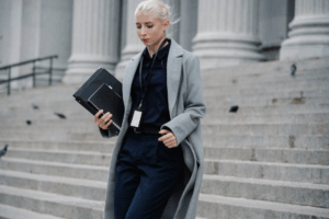 An attorney walks down courthouse steps with case files, symbolizing a Houston divorce law firm supporting clients through litigation.