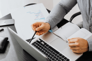 Person analyzing financial charts with guidance from a Texas property division attorney.