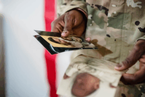 a man in the military looking at family pictures