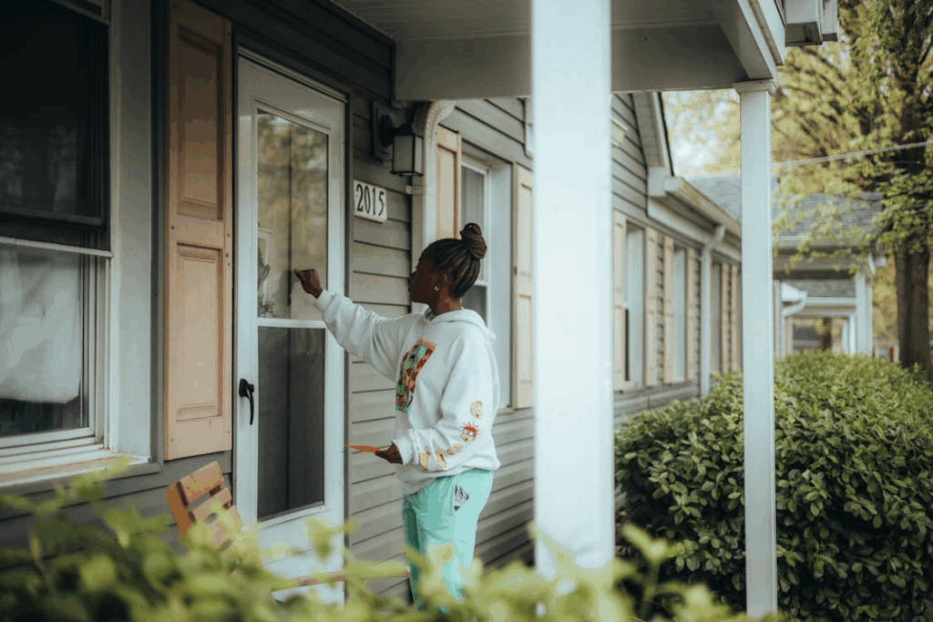 a woman knocking on a house door