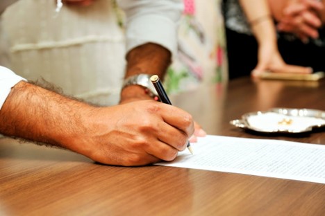A person writing on white paper