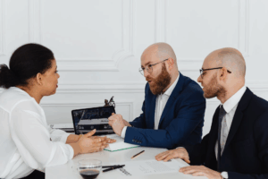 Houston attorney explaining prenuptial agreement terms to a couple during a meeting