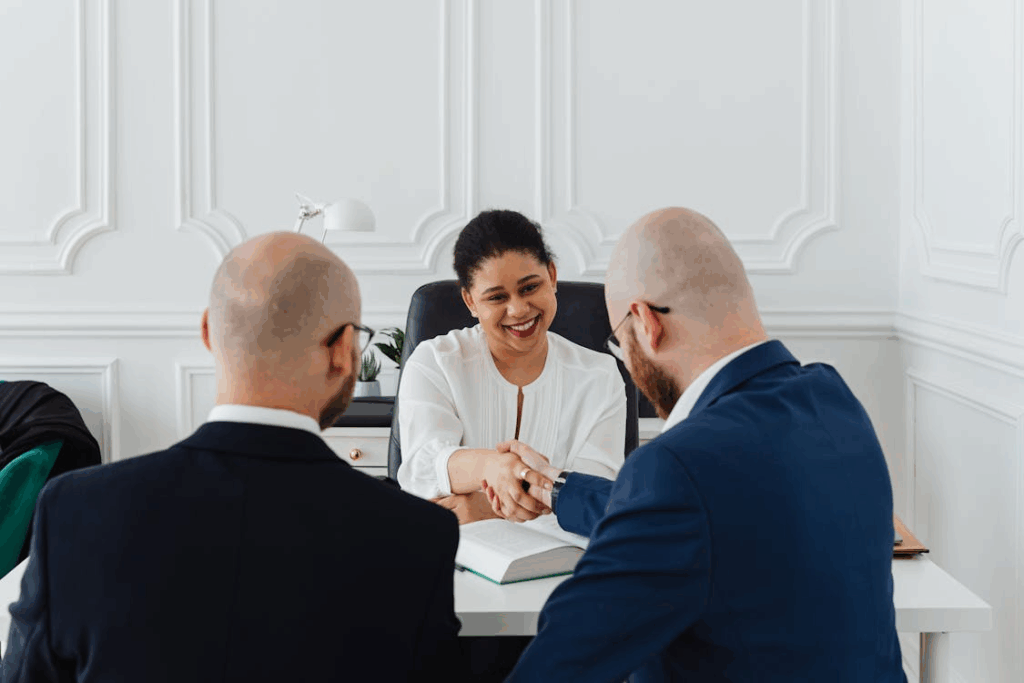 Attorney shaking hands with a couple after discussing prenuptial agreement in Houston