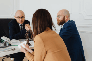 Family lawyer in Houston meeting with a couple to discuss prenuptial agreement options