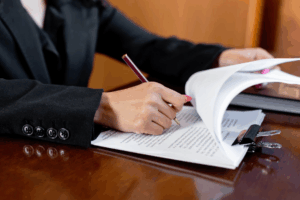 Professional family lawyer in Houston reviewing court documents at her desk.