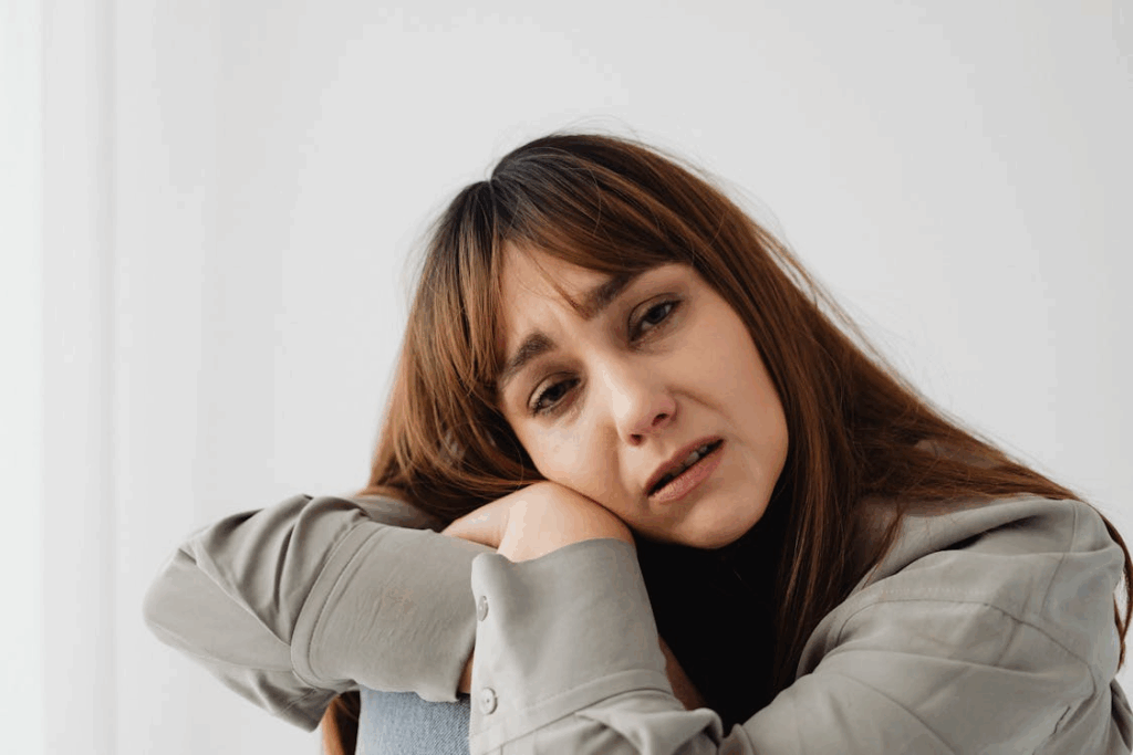 Woman sitting up in bed at night feeling stressed about divorce