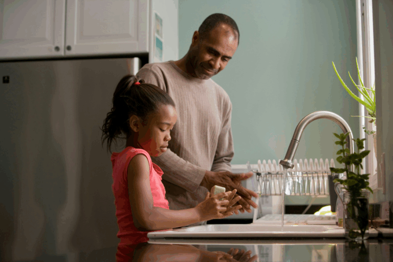 A man and a kid washing hands
