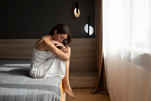 A woman sitting on a bed