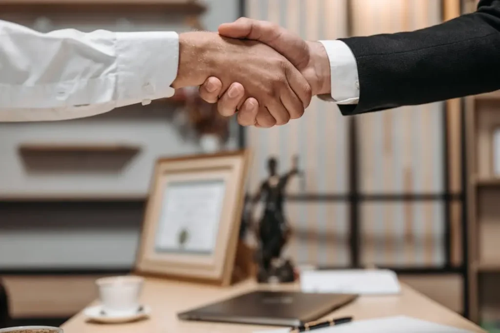 A lawyer and client shake hands.