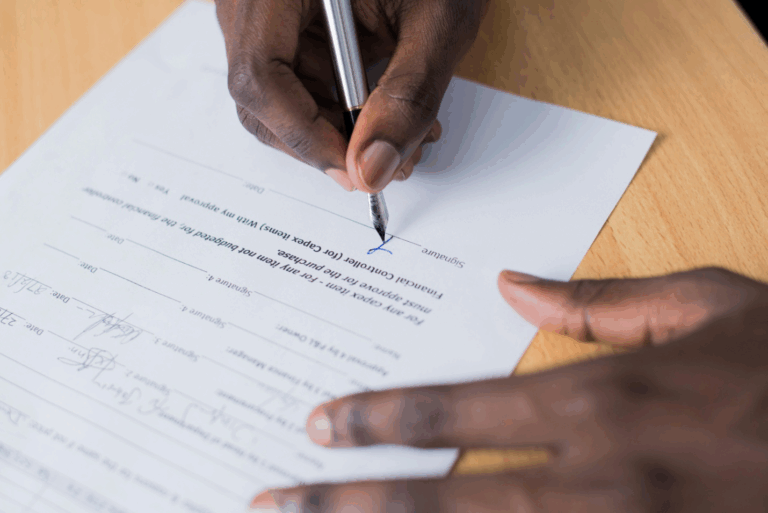 A person signing a form