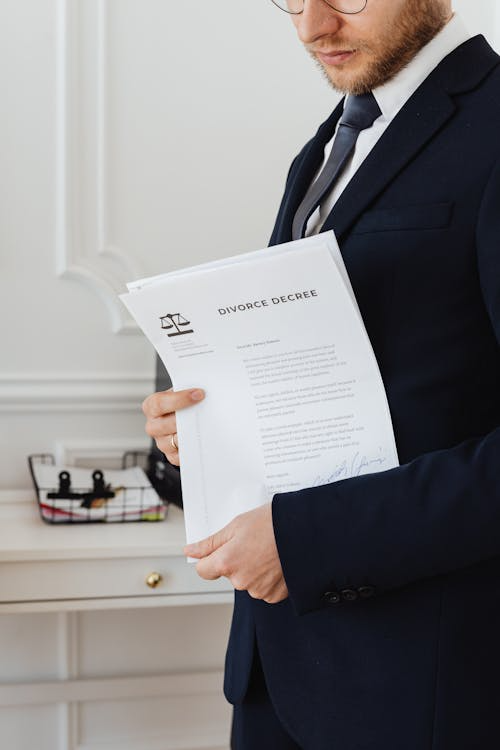 Uncontested divorce lawyer holding documents for clients.