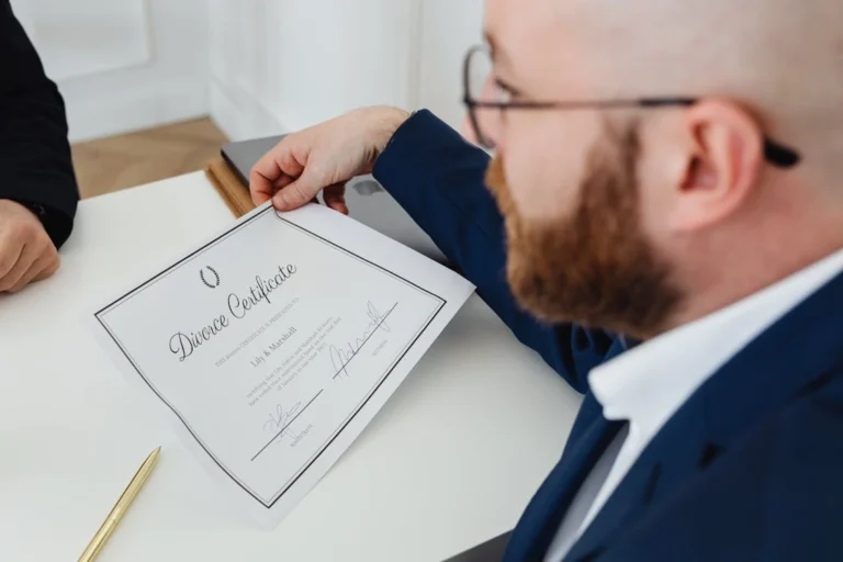 A man holding a divorce certificate at a divorce attorney’s office in Shavano Heights, San Antonio, TX