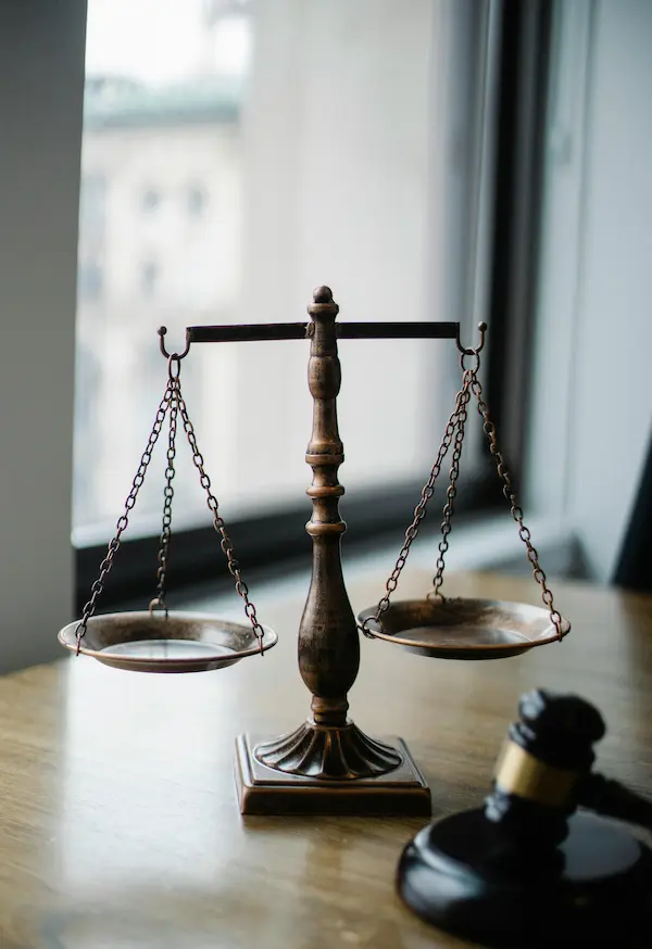 A gavel next to the scales