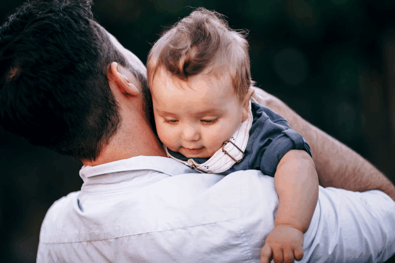 a father holding a baby