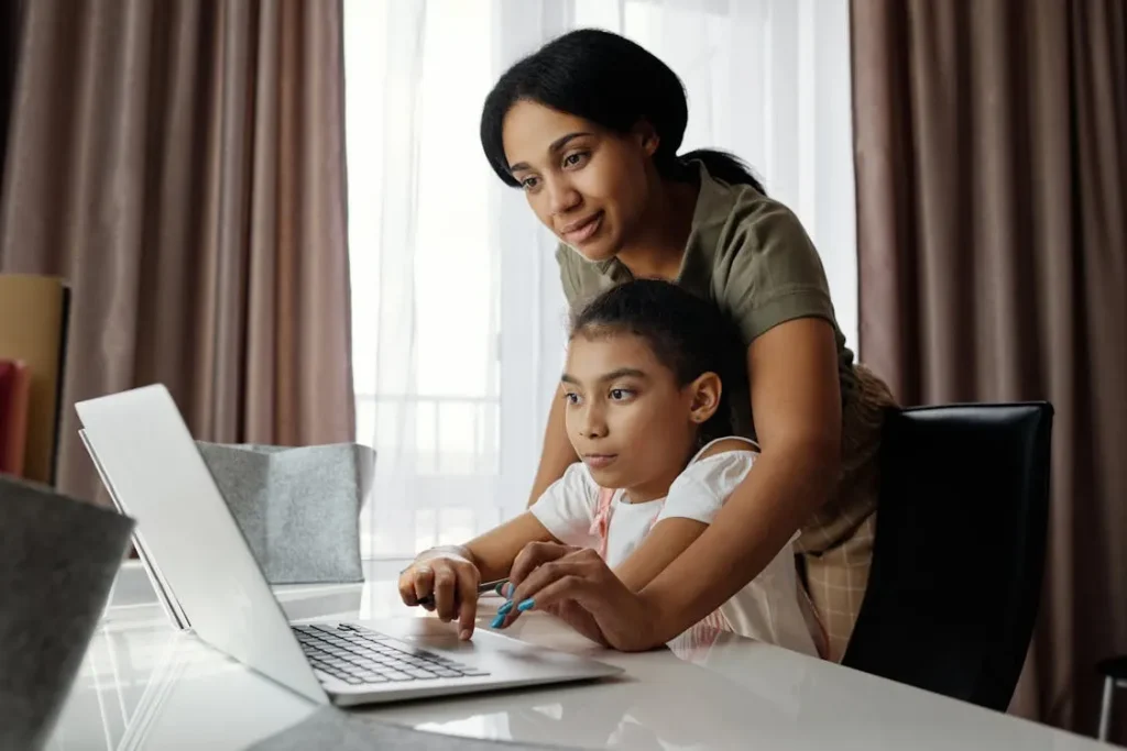 Mother and daughter using a laptop together, symbolizing family support and custody planning with an experienced family law attorney in Vidor