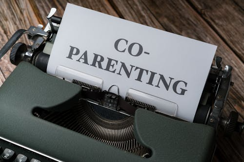 Typewriter with the words co-parenting written on paper