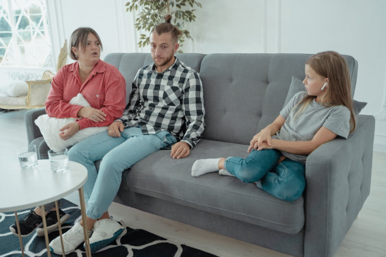an upset family sitting on a couch