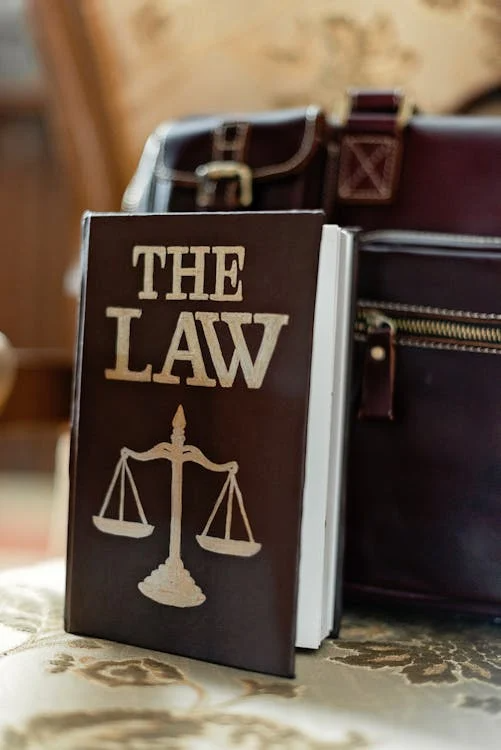 a book about the law in front of a briefcase