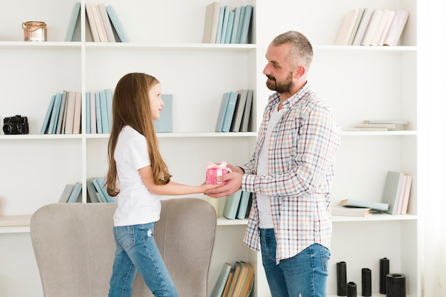 A father visiting her daughter with a gift