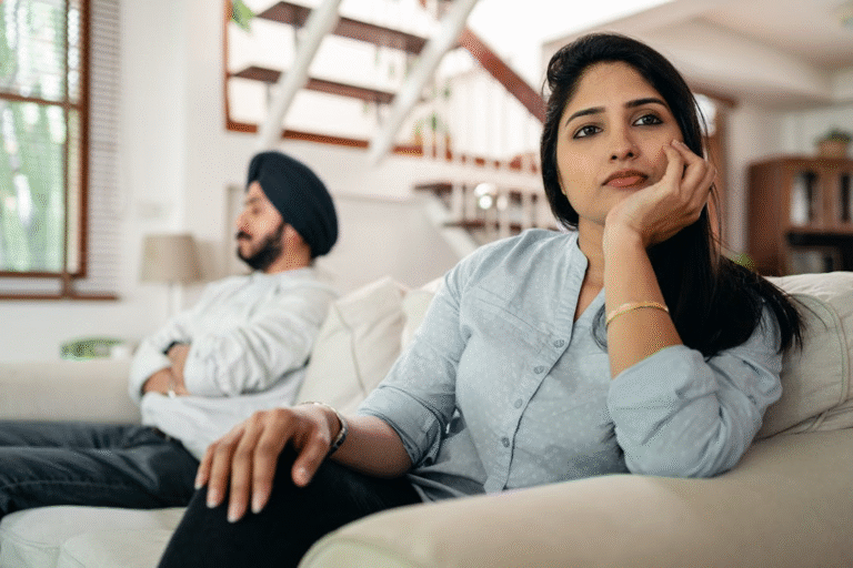 Woman sitting on a sofa, avoiding eye contact with a man