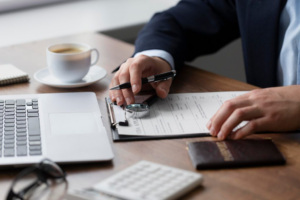 A lawyer preparing legal papers and using a laptop.