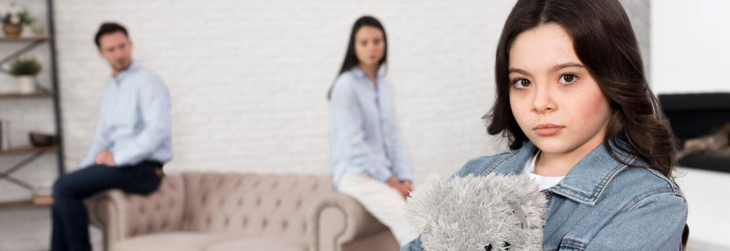 A child holding a teddy bear in their arms.