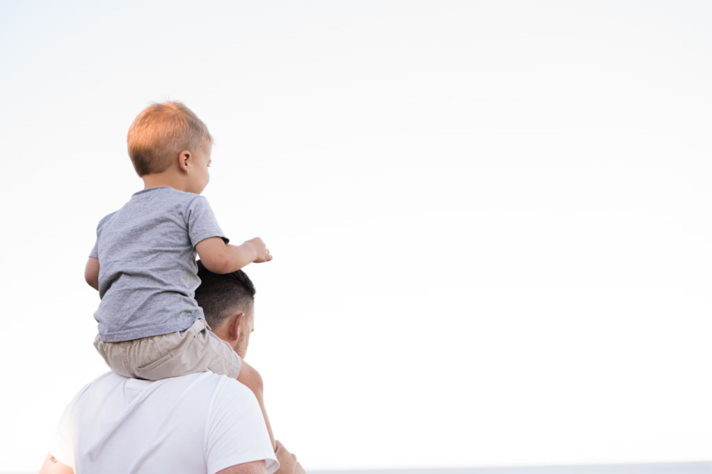 A father carrying his son on his shoulders