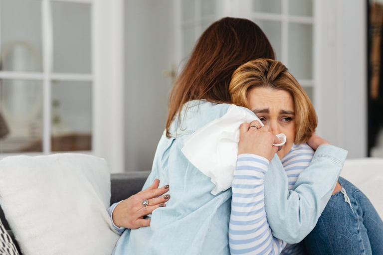 a sad mother hugging her child