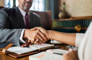 Two people shaking hands together.