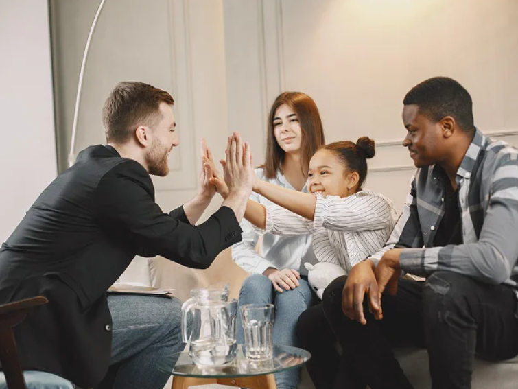 A couple sitting with a child and an attorney.