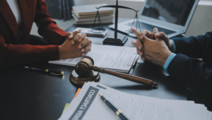 This is the picture that shows a lawyer’s table with documents and a gavel.